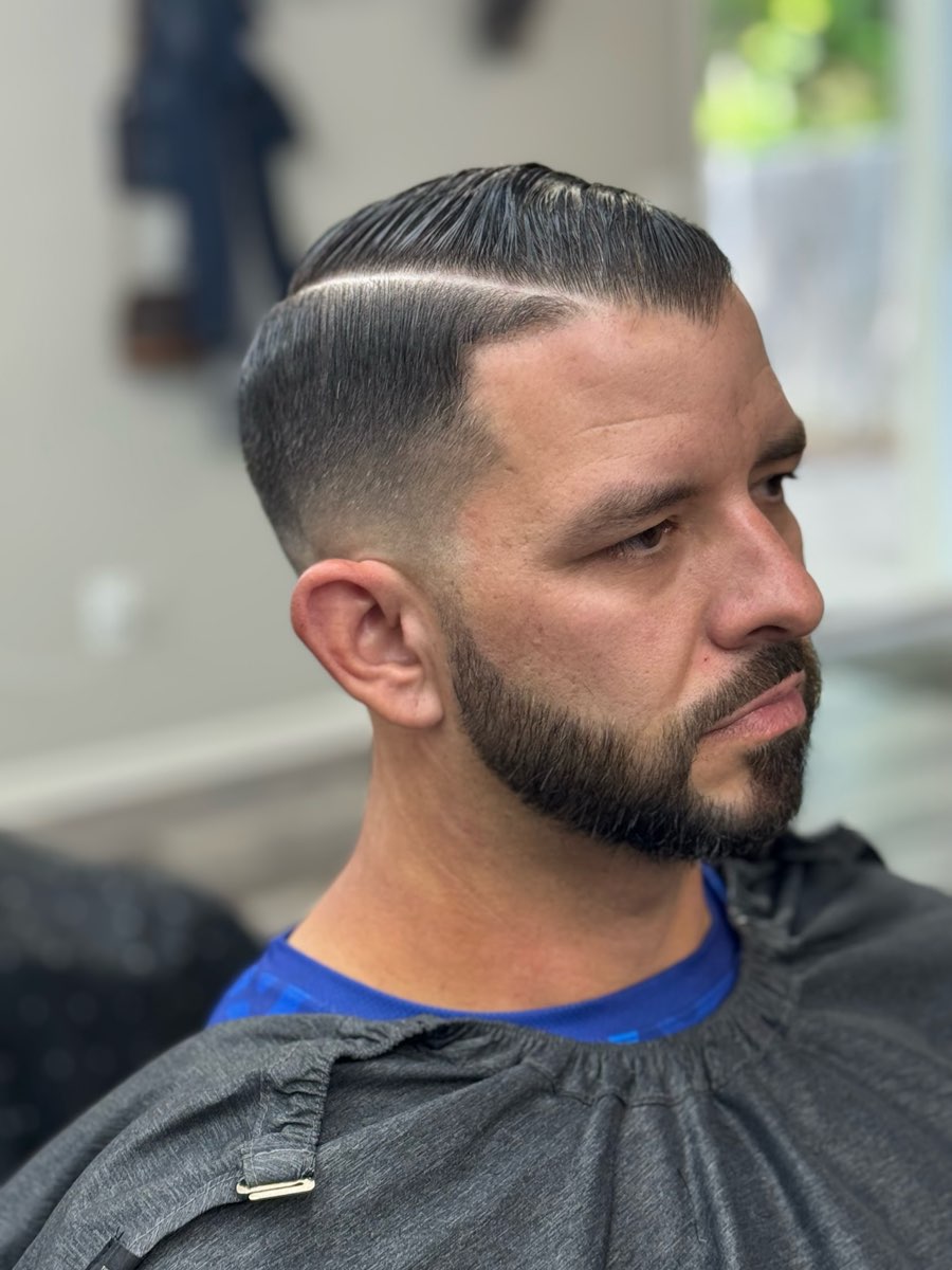 Hard part with a skin fade and a sculpted beard